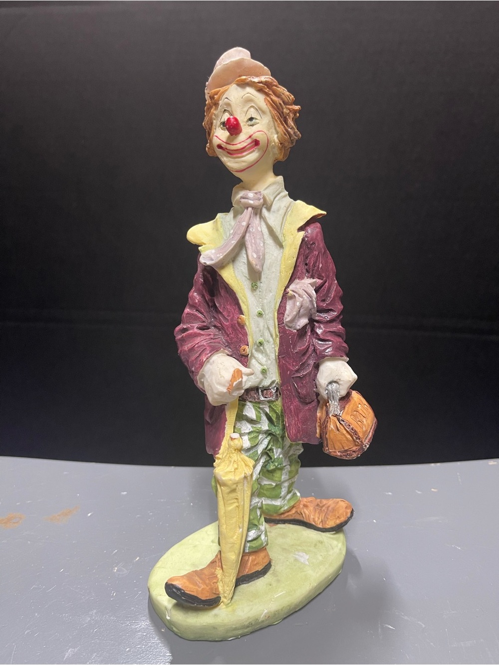 Vintage Albert E. Price Products poly clown figurine featuring a bank ba